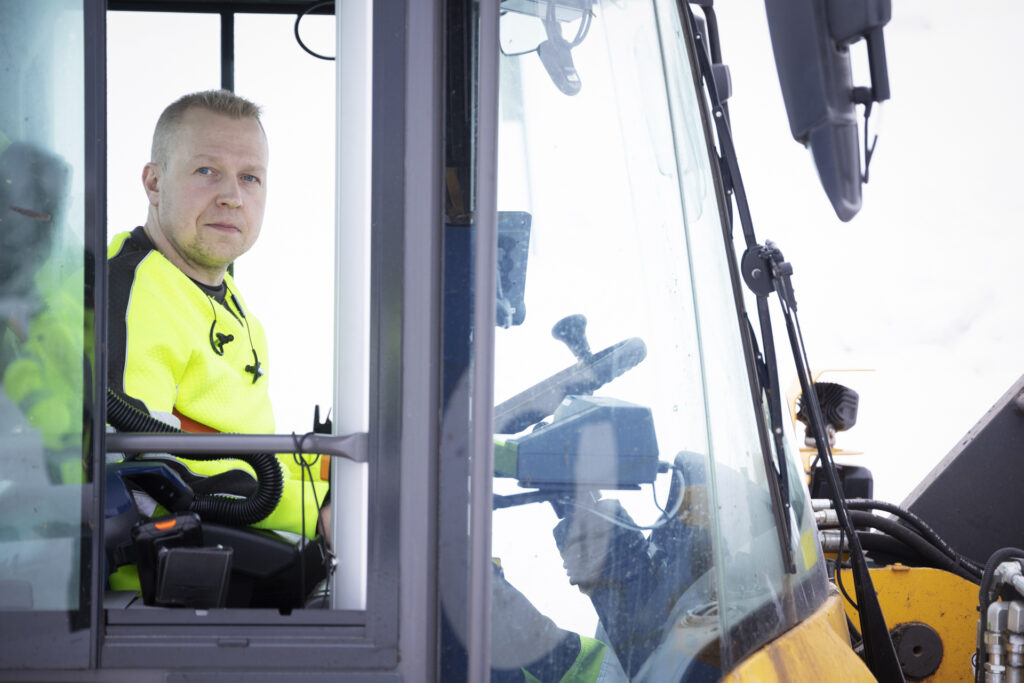 Mies katsoo pyöräkoneen ikkunasta kameraan