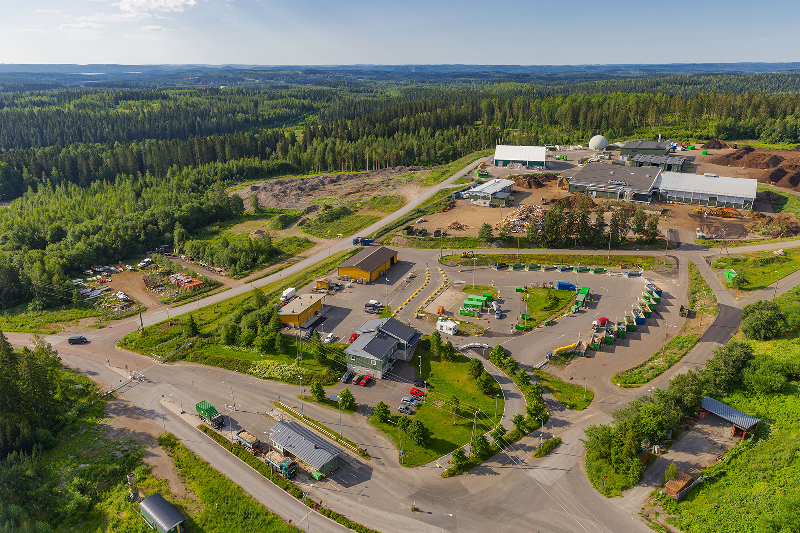 Ilmakuva jätekeskuksesta. Ilmakuvassa näkyy erilaisia rakennuksia ja taustalla paljon metsää.
